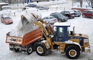 Погрузка снега в самосвал трактором-погрузчиком JCB